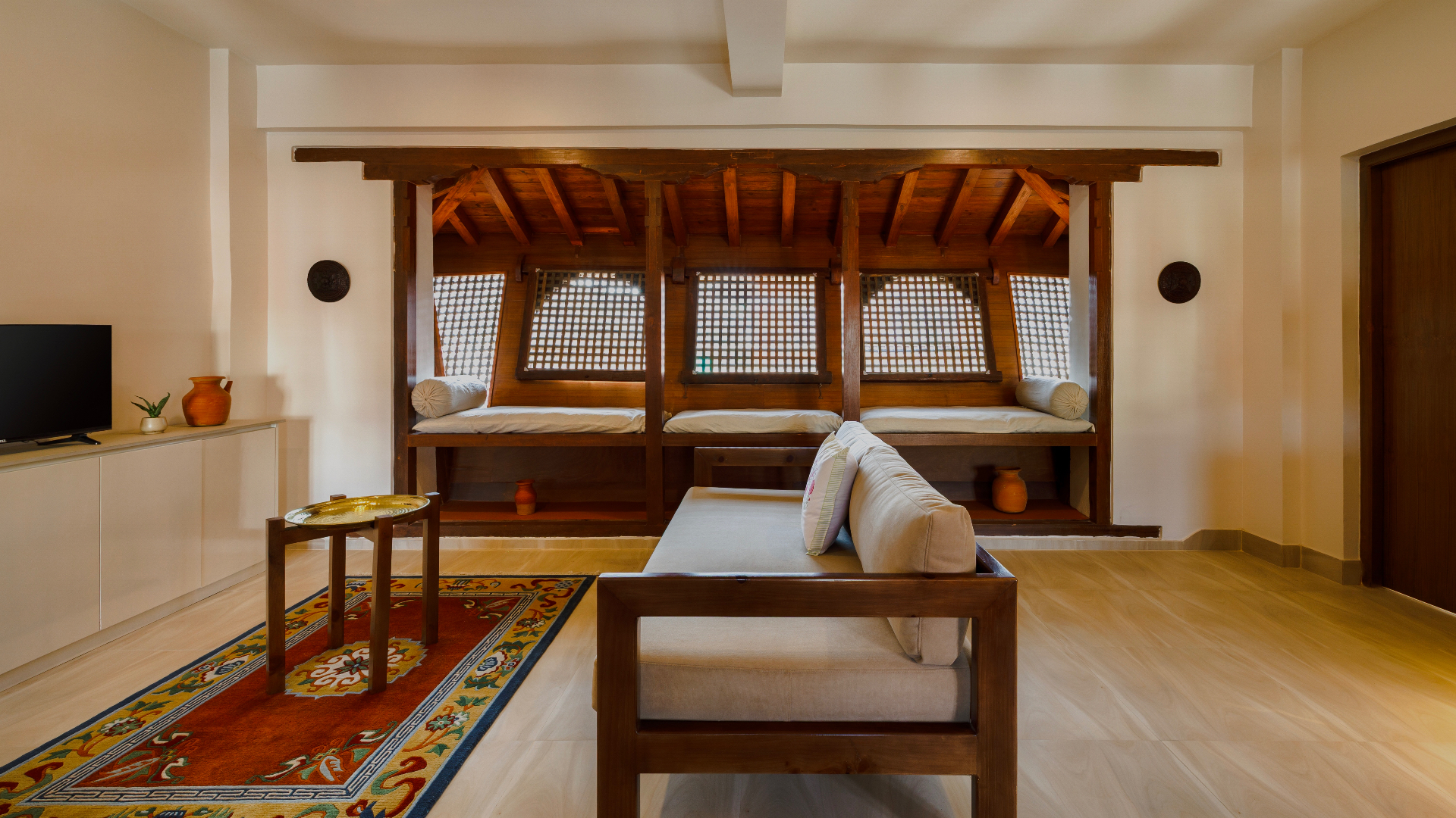 A serene suite at Newa Suites with carved Newa lattice window and warm morning light